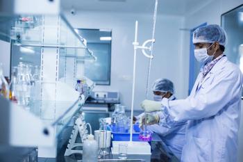 workers in lab wearing personal protective equipment