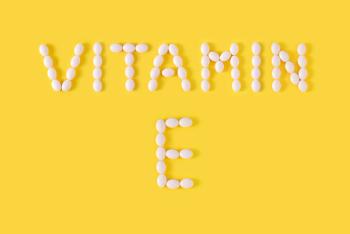 vitamin E spelled with pills on yellow background
