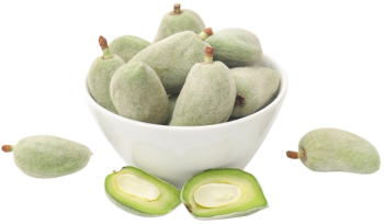 bowl of green almonds with on split in half