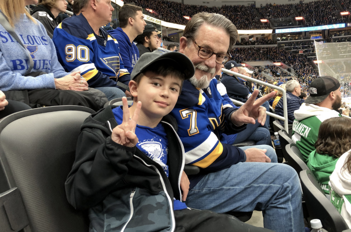 DiPersio, here with his son, Jack, at a Blues game. DiPersio played hockey in college, but an eye injury ended his career.