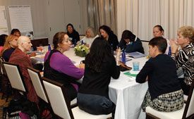 articipants interact at a Cancer and Careers educational event.