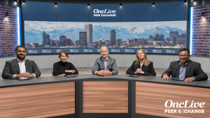 A panel of 5 experts on lung cancer seated at a long table