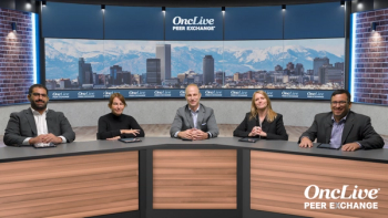 A panel of 5 experts on lung cancer seated at a long table