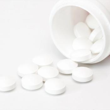 bottle of white pills on its side