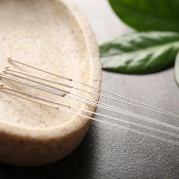 Photo of acupuncture needles resting in a bowl