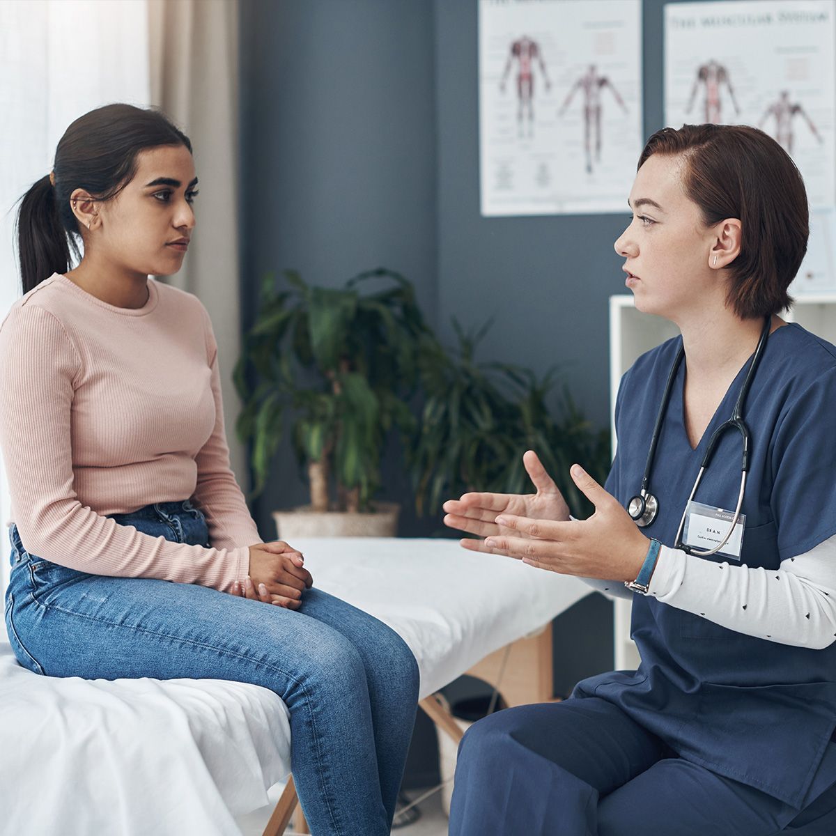 Image of a young adult patient talking with a nurse