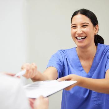 Nurse handing a patient a clipboard