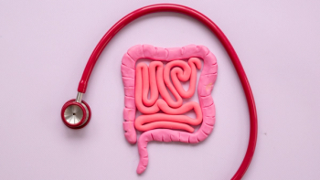 Image of a three-dimensional model of a gastrointestinal tract with a stethascope surrounding it in an arc shape.