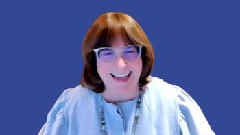 Photo of a woman with brown hair and bangs