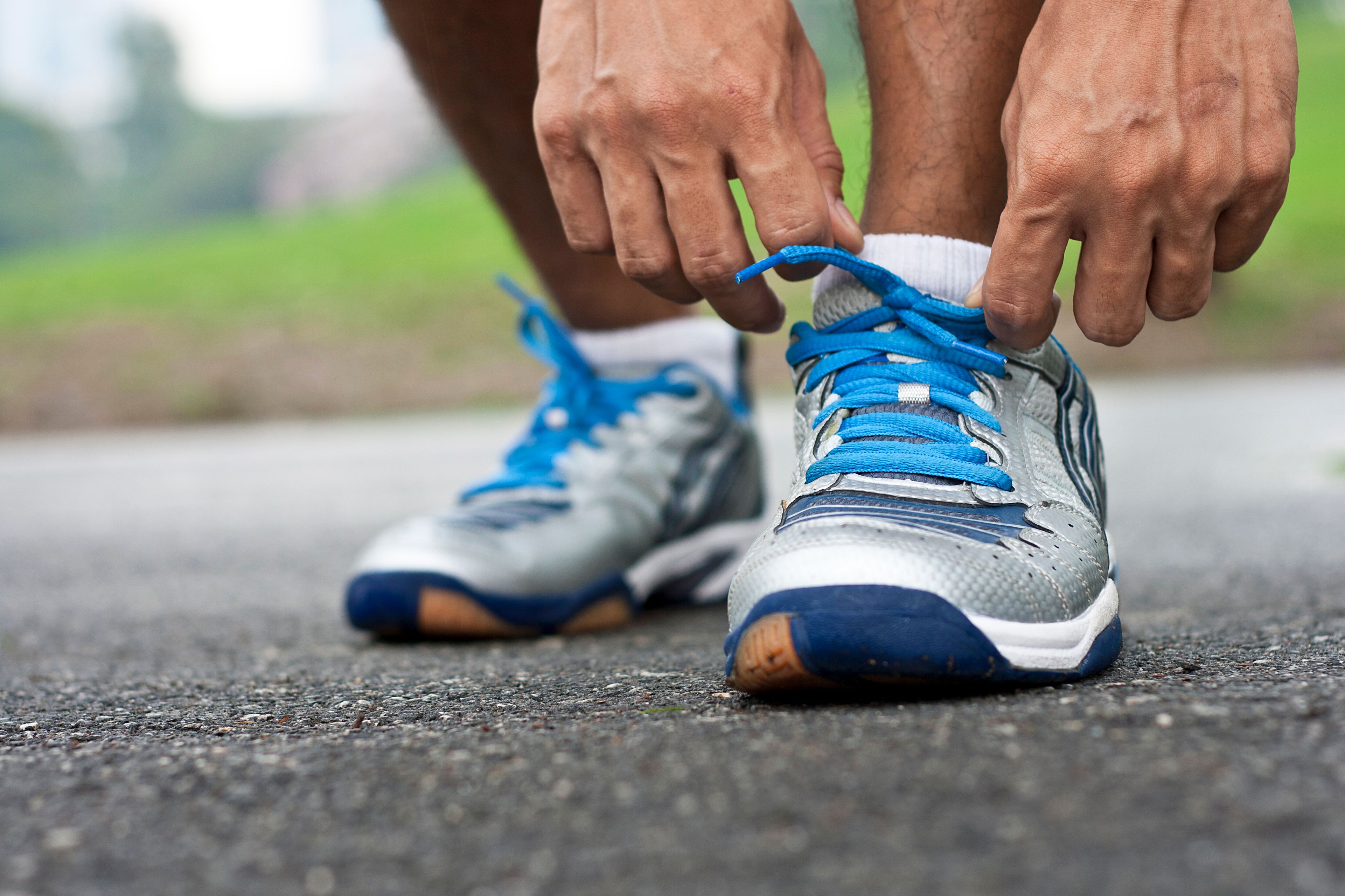 Man Ties Running Sneakers