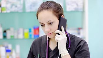 Image of a nurse holding a cell phone