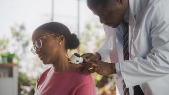 Photo of a man in a medical coat evaluating the skin of a Black woman