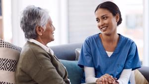Photo of a nurse holding a patient's hand