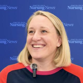 Photo of a woman with shoulder-length blond hair in front of an Oncology Nursing News backdrop