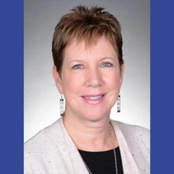Photo of a woman with short hair wearing a sweater