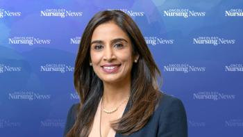 Image of a woman with dark brown hair wearing a blazer in front of an Oncology Nursing News bakcground