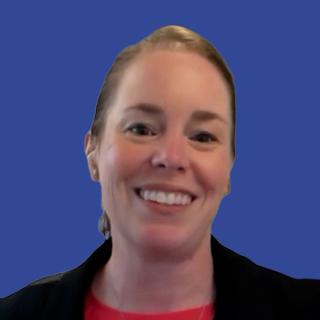 Photo of a woman smiling in front of a dark blue background