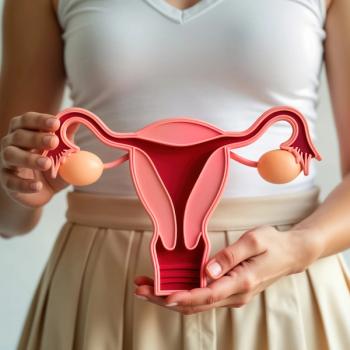 Image of a person holding a model of the female reproductive system