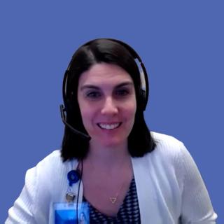 Image of a woman with shoulder-length black hair wearing headphones and a white sweater