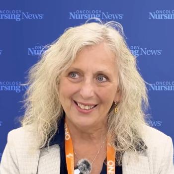 Photo of a woman with blond wavy hair wearing a blazer in front of a blue Oncology Nursing News background