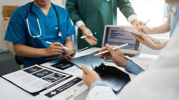Photo of health professionals collaborating with papers and tablets