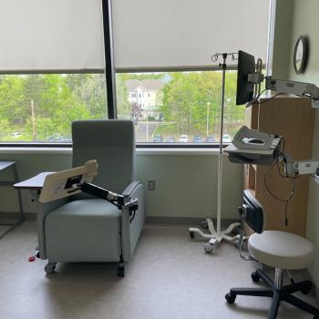 Photo of a private infusion bay with a large screen for video calls