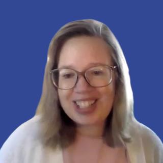 Image of a woman with glasses in front of a blue background