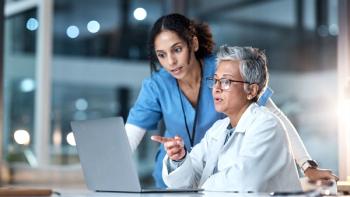 Photo of a nurse and APP looking at a computer
