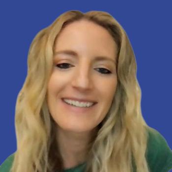 Image of a woman with blond hair wearing a green shirt in front of a blue background