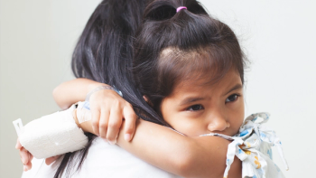 Sick asian child girl who have IV solution bandaged hugging her mother with love in the hospital © pingpao - stockadobe.com