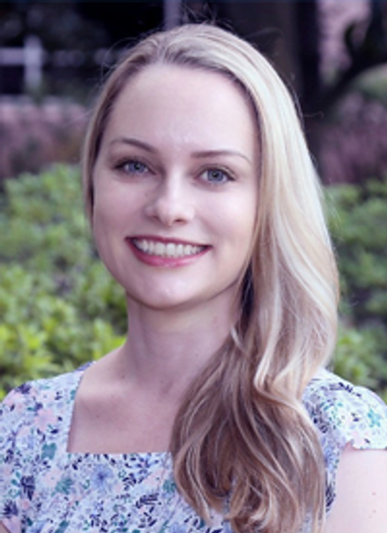 Photo of a woman with blond hair in front of a greenery background