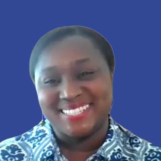 Image of a woman wearing a patterned shirt in front of a dark blue background