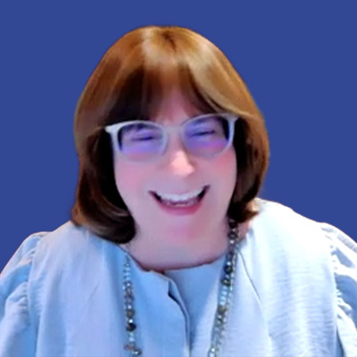 Photo of a woman with shoulder-length hair wearing a blue blouse