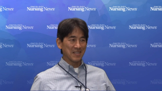 Man standing in front of Oncology Nursing News-branded backdrop