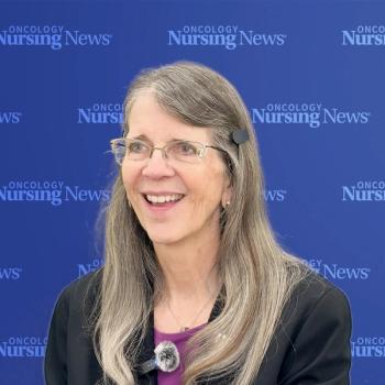 Image of a woman with gray hair and glasses in front of a blue Oncology Nursing News background
