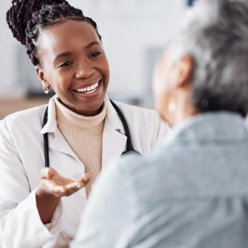 Photo of an APP talking to and empowering a patient