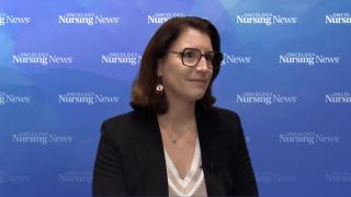 Image of a woman in front of a blue Oncology Nursing News-branded backdrop.