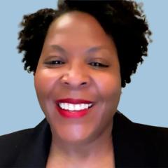 Image of a woman with brown hair wearing a blazer