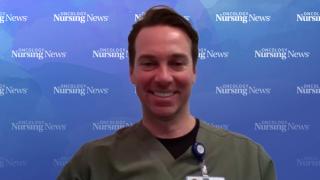 Image of a man wearing scrubs and a name tag in front of a watercolor Oncology Nursing News background