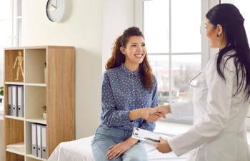 Photo of a nurse and a patient talking