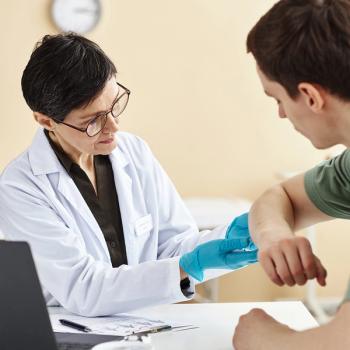 Photo of a health care specialist examining a patient's skin