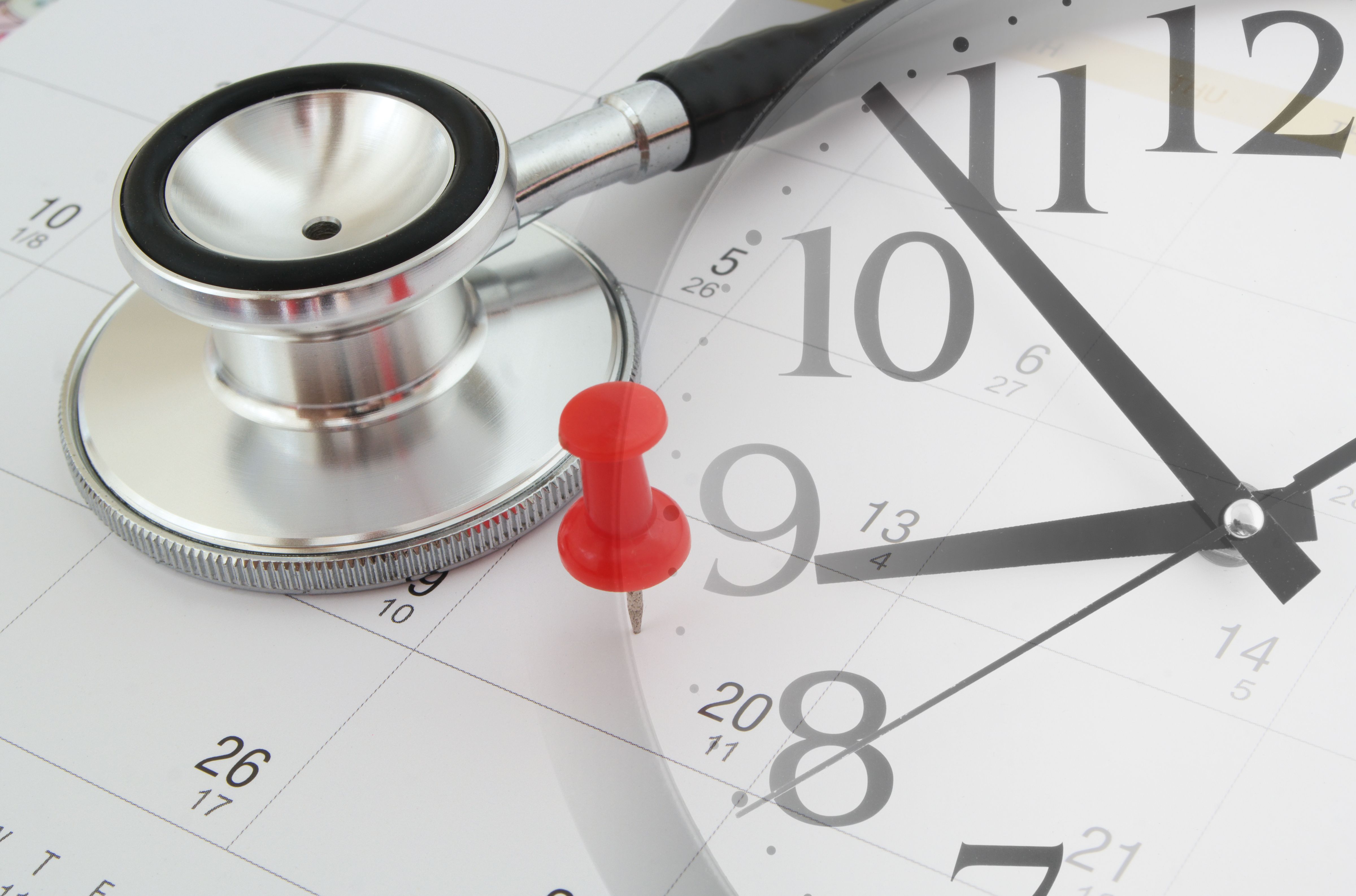 Image of a calendar with a thumb tack stuck on a day reading "20," and a stethoscope lying on the calendar, with an image of a clock overlaying