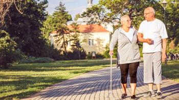 Photo of an older couple walking in a park