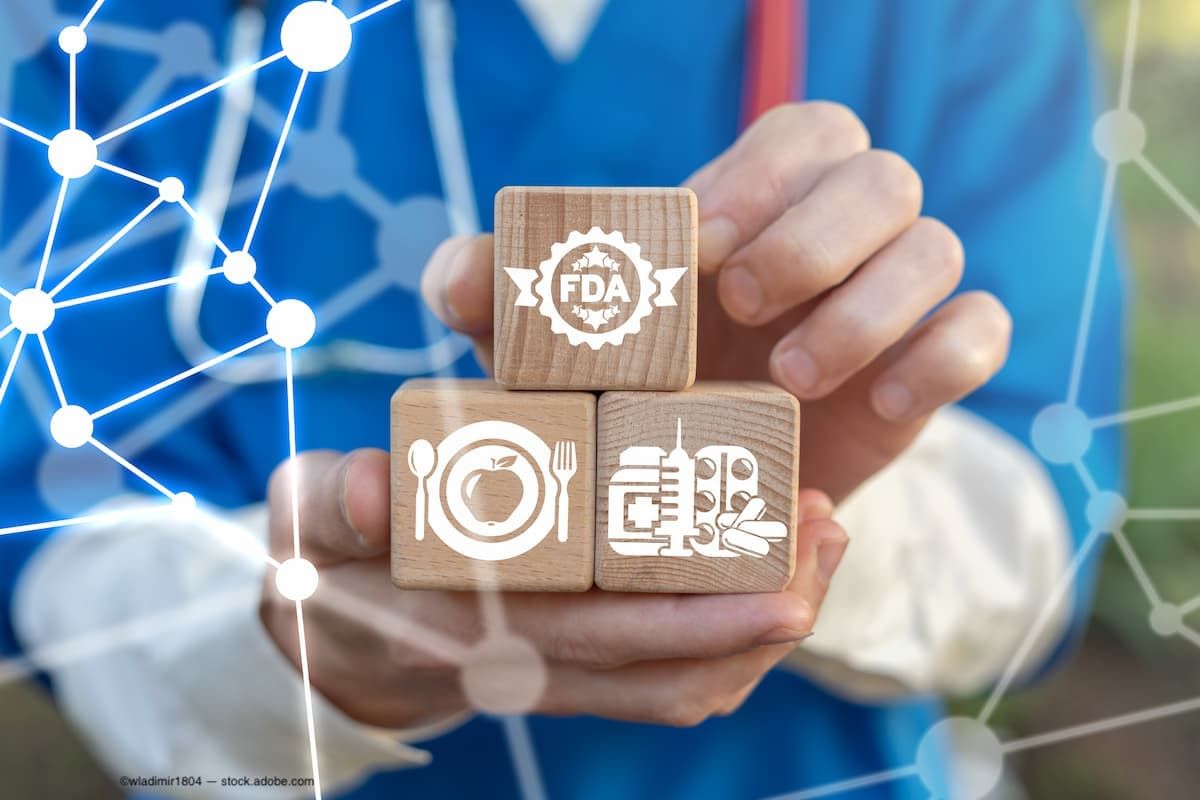 a doctor holding blocks with medical symbols and the FDA logo on them