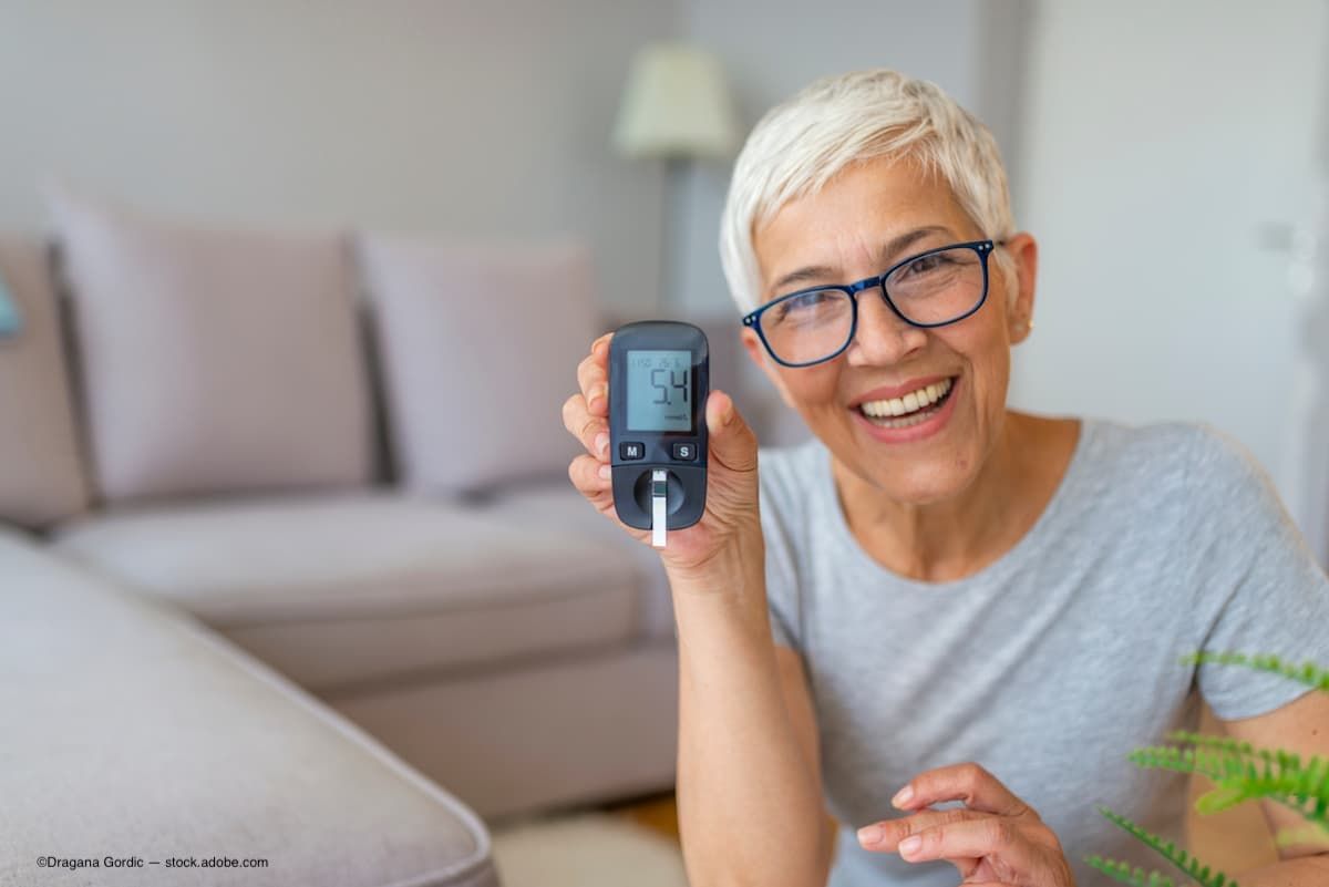 an older woman wearing glasses with diabetes checking her blood sugar levels.