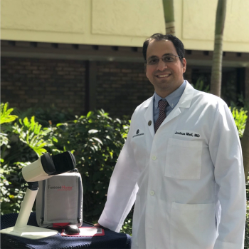 Dr. Mali. pictured here with the AMD monitoring device