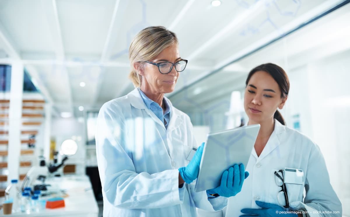Women, scientist and discussion with tablet by glass, reading and review with results at pharma company. People, mentor and feedback with notes, application and medical research for mpox vaccine (Image credit: ©peopleimages.com/AdobeStock)
