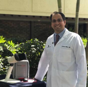 Dr. Mali. pictured here with the AMD monitoring device