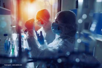 A group of researchers examine test tubes in a laboratory. Image credit: ©alphaspirit – stock.adobe.com