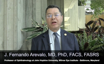 Fernando Arevalo, MD, PhD, FACS, FASRS, stands against a backdrop as he is interviewed at the 2023 ASRS annual meeting.